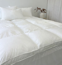 Mainlinen Guest Comfort 1000GSM down alternative mattress topper on a hotel bed
