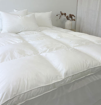 Mainlinen Guest Comfort 1000GSM down alternative mattress topper on a hotel bed